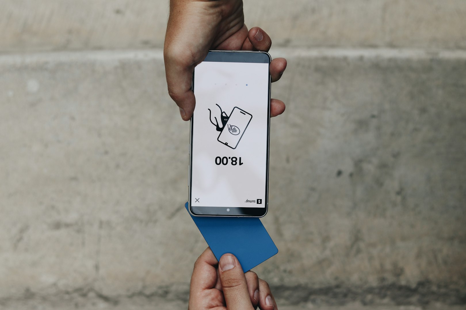 A person holding a box with a cat on it